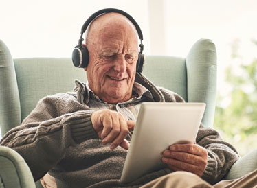 Man on tablet using headphone